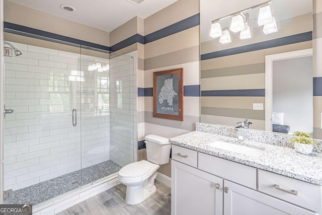 2675 Sugar Mill Dr, Atlanta, GA 30316 - full bath with vanity, wood finished floors, toilet, and a shower stall