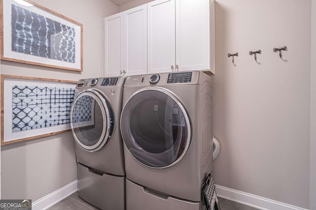 2675 Sugar Mill Dr, Atlanta, GA 30316 - washroom featuring cabinet space, baseboards, tile patterned flooring, and washing machine and clothes dryer
