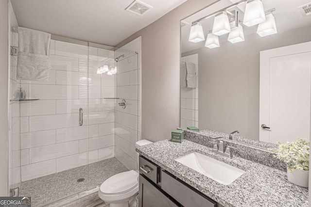 2675 Sugar Mill Dr, Atlanta, GA 30316 - bathroom with visible vents, vanity, toilet, and a shower stall