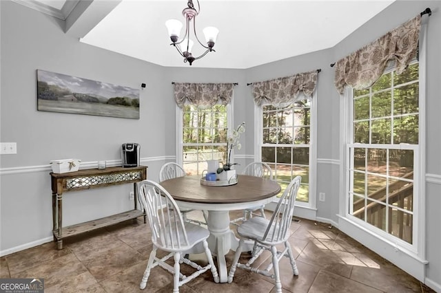 dining room with a chandelier, a wealth of natural light, tile patterned floors, and baseboards