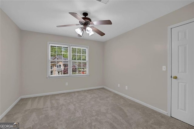 spare room featuring baseboards, a ceiling fan, and carpet flooring