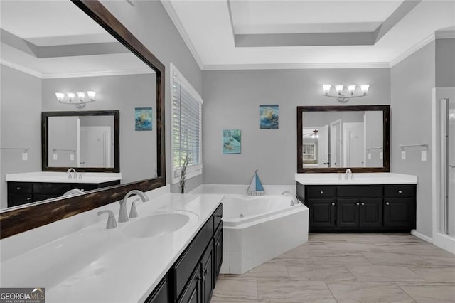 full bath featuring a sink, marble finish floor, a tray ceiling, a jetted tub, and a notable chandelier