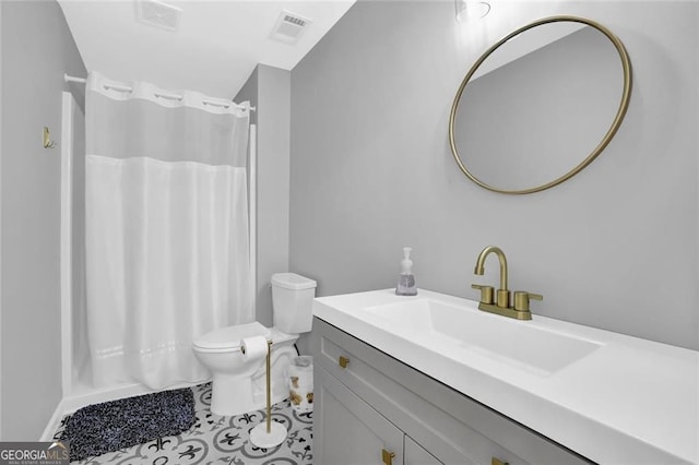bathroom with visible vents, tile patterned floors, vanity, and toilet