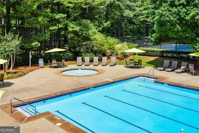 pool featuring fence and a patio