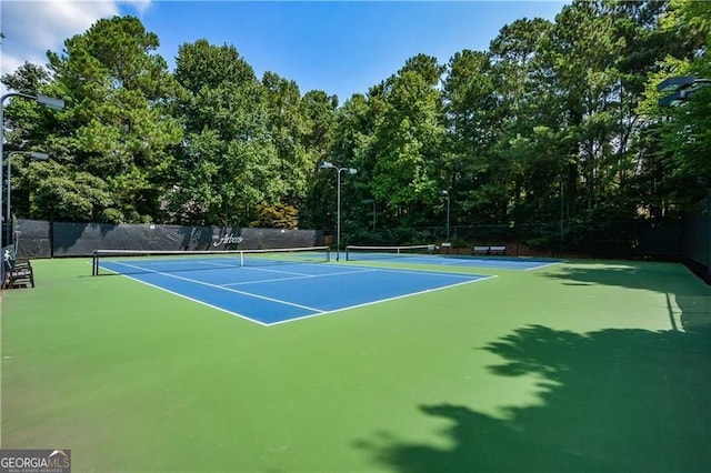 view of sport court featuring fence