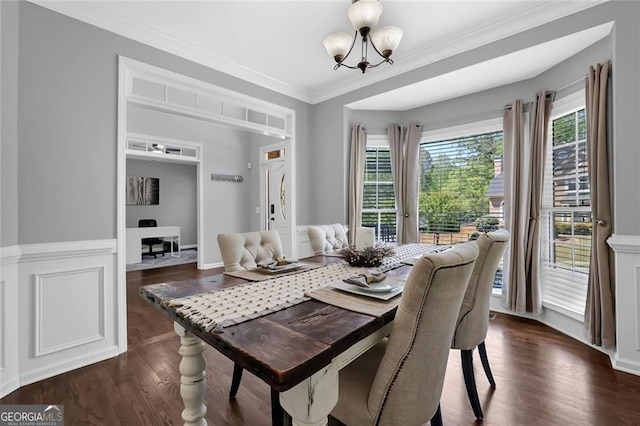 dining area featuring a chandelier, crown molding, and dark wood-style floors