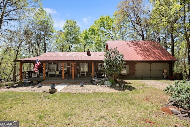 366 Crabapple Rdg, Clarkesville, GA 30523 - view of front facade with dirt driveway, a chimney, a front lawn, a porch, and metal roof