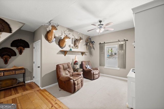 366 Crabapple Rdg, Clarkesville, GA 30523 - sitting room with a ceiling fan, baseboards, hardwood / wood-style flooring, and a barn door