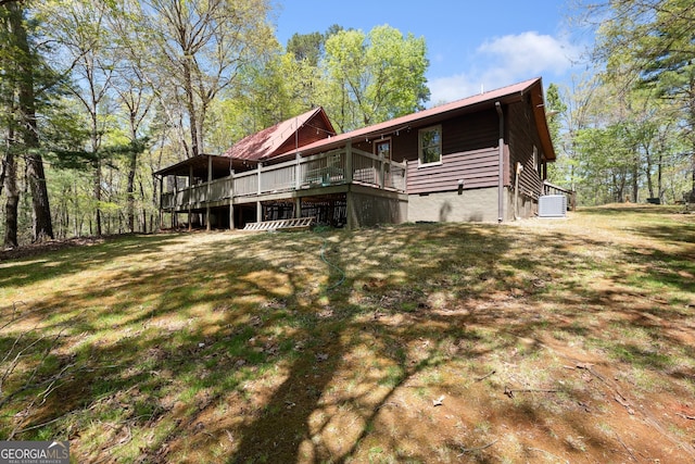 366 Crabapple Rdg, Clarkesville, GA 30523 - rear view of house featuring a wooden deck, a lawn, and central AC unit