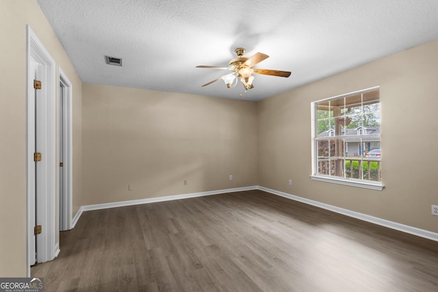 203 Old Pond Dr W, Kingsland, GA 31548 - empty room with wood finished floors, ceiling fan, baseboards, and a textured ceiling