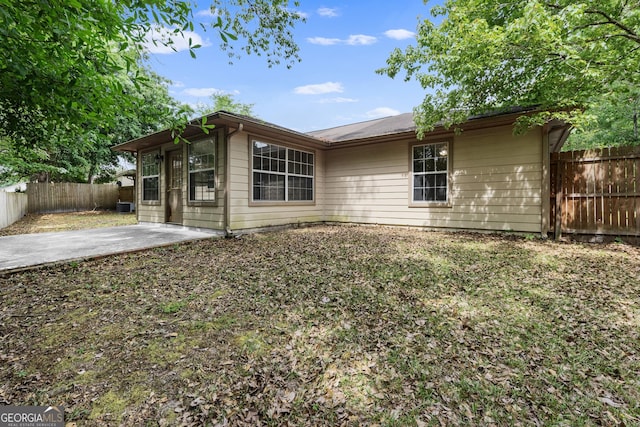 203 Old Pond Dr W, Kingsland, GA 31548 - back of house with a fenced backyard and a patio area