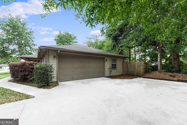 203 Old Pond Dr W, Kingsland, GA 31548 - view of side of property featuring concrete driveway, fence, and an attached garage