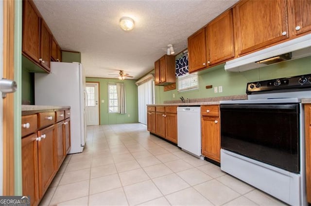 1530 Mcbrayer, Temple, GA 30179 - kitchen featuring white appliances, under cabinet range hood, light countertops, brown cabinets, and ceiling fan