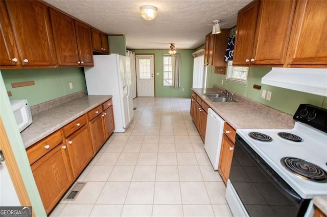 1530 Mcbrayer, Temple, GA 30179 - kitchen featuring white appliances, a sink, ventilation hood, a textured ceiling, and brown cabinetry