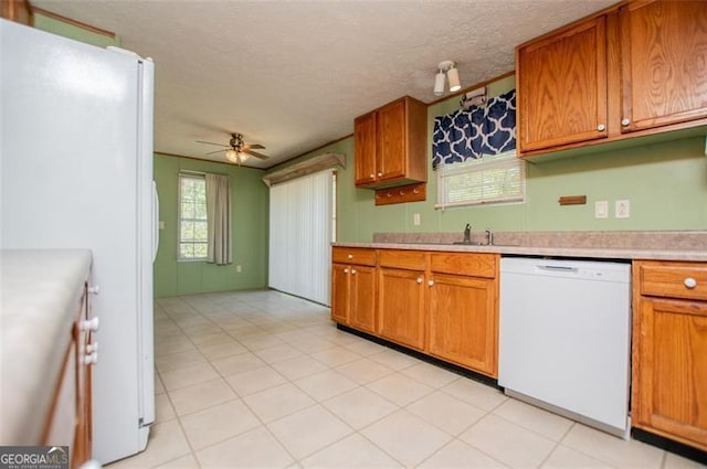 1530 Mcbrayer, Temple, GA 30179 - kitchen featuring white appliances, a ceiling fan, light countertops, brown cabinetry, and a textured ceiling