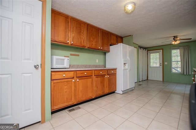 1530 Mcbrayer, Temple, GA 30179 - kitchen with white appliances, light countertops, brown cabinetry, a textured ceiling, and ceiling fan