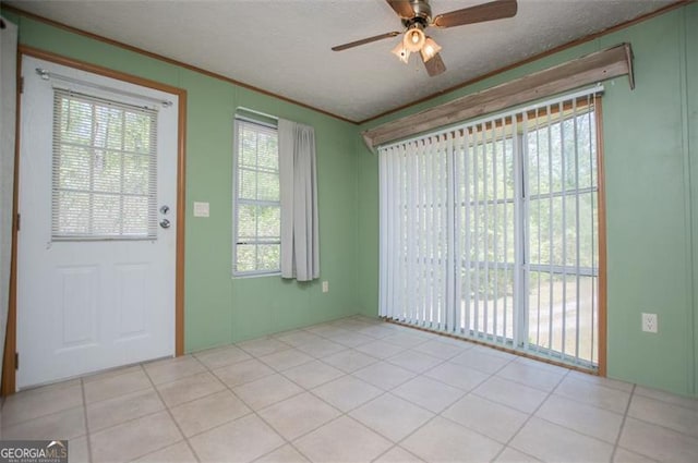 1530 Mcbrayer, Temple, GA 30179 - spare room featuring crown molding, ceiling fan, plenty of natural light, light tile patterned flooring, and a textured ceiling