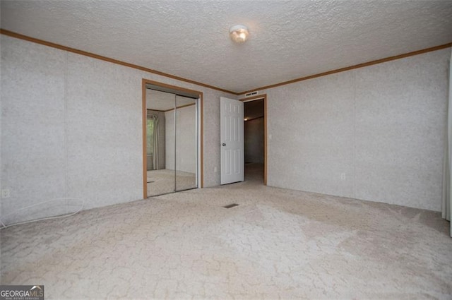 1530 Mcbrayer, Temple, GA 30179 - unfurnished bedroom featuring crown molding, carpet floors, a closet, and a textured ceiling