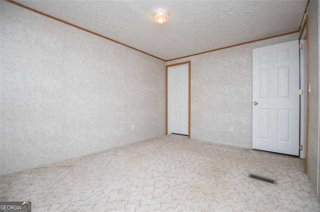 1530 Mcbrayer, Temple, GA 30179 - empty room featuring crown molding, carpet flooring, and a textured ceiling