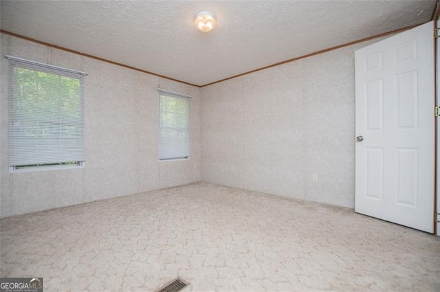 1530 Mcbrayer, Temple, GA 30179 - carpeted empty room featuring crown molding, plenty of natural light, and a textured ceiling