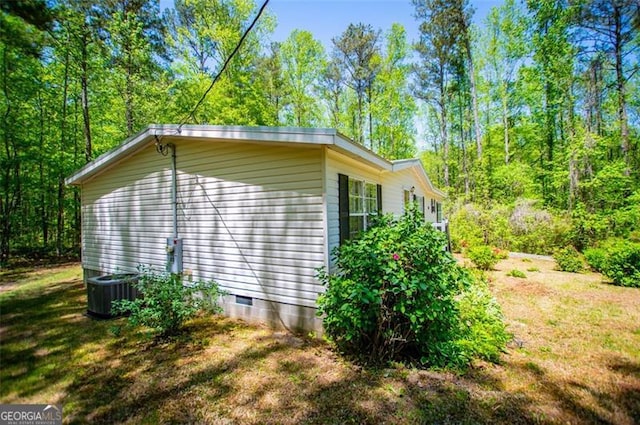 1530 Mcbrayer, Temple, GA 30179 - view of home's exterior featuring crawl space, central AC unit, and a forest view