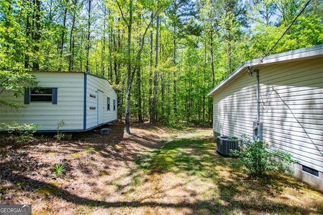 1530 Mcbrayer, Temple, GA 30179 - view of yard featuring central air condition unit, a wooded view, and an outbuilding