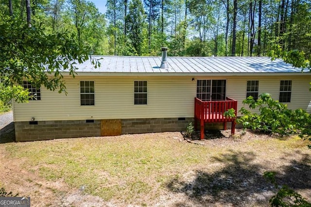 1530 Mcbrayer, Temple, GA 30179 - rear view of house with crawl space, a deck, metal roof, and a lawn