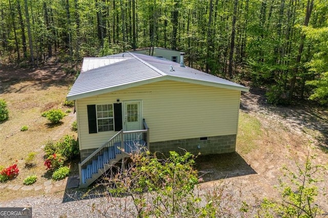 1530 Mcbrayer, Temple, GA 30179 - view of side of home with a forest view, crawl space, and metal roof