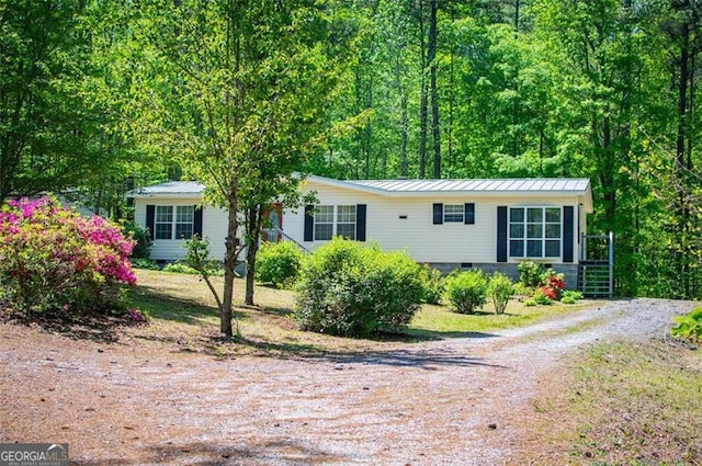 1530 Mcbrayer, Temple, GA 30179 - view of front of house with a standing seam roof, metal roof, and driveway