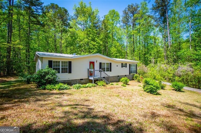 1530 Mcbrayer, Temple, GA 30179 - manufactured / mobile home featuring crawl space, a front yard, and a forest view