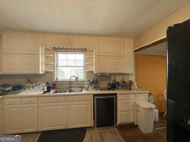 1105 College St, Bainbridge, GA 39819 - kitchen featuring open shelves, dark wood-style floors, light countertops, white cabinetry, and a sink