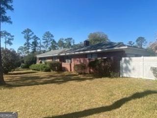 1105 College St, Bainbridge, GA 39819 - rear view of house featuring a lawn