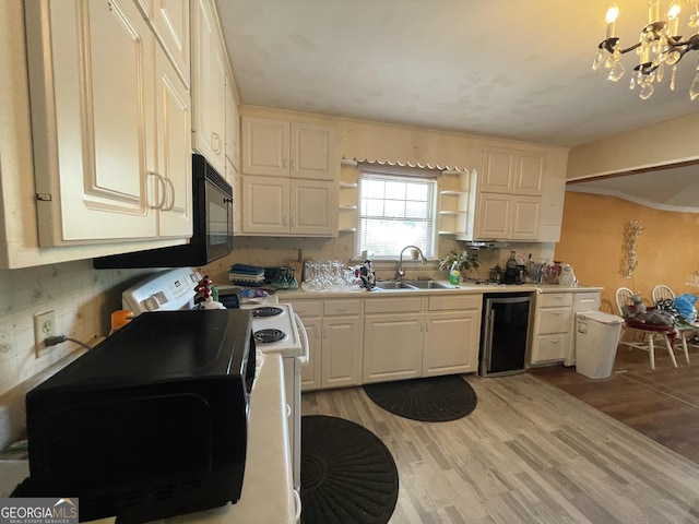 1105 College St, Bainbridge, GA 39819 - kitchen featuring open shelves, a notable chandelier, a sink, light countertops, and light wood-type flooring