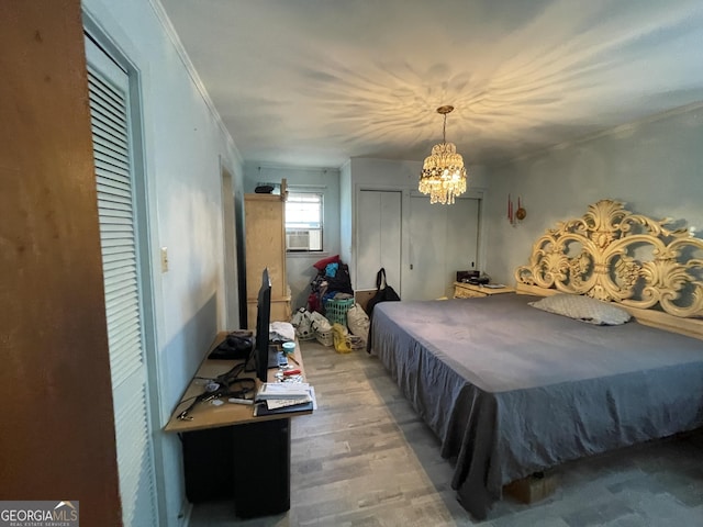 1105 College St, Bainbridge, GA 39819 - bedroom featuring crown molding, cooling unit, wood finished floors, and a chandelier
