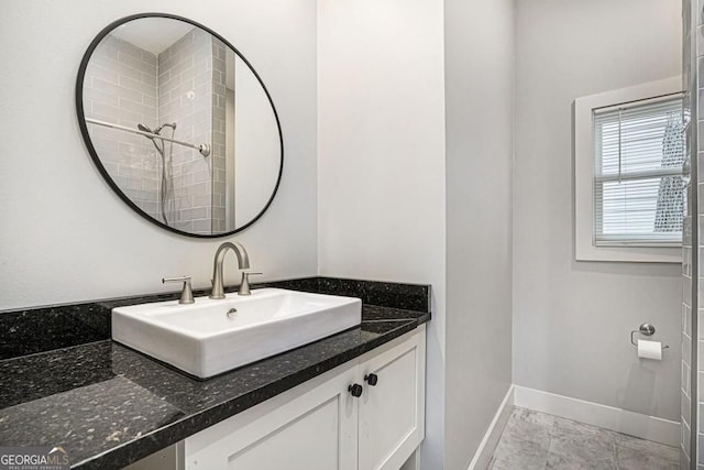 bathroom featuring baseboards and vanity