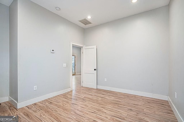 unfurnished room with recessed lighting, light wood-style floors, visible vents, and baseboards