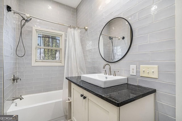 bathroom with tile walls, vanity, shower / bathtub combination with curtain, and tasteful backsplash