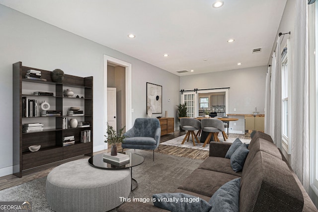 living room featuring recessed lighting, wood finished floors, and visible vents