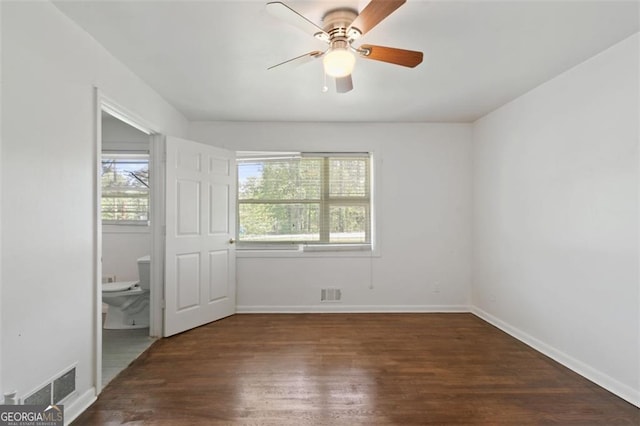 3501 Wesley Chapel Rd, Decatur, GA 30034 - unfurnished bedroom with wood finished floors, baseboards, ensuite bath, and a ceiling fan