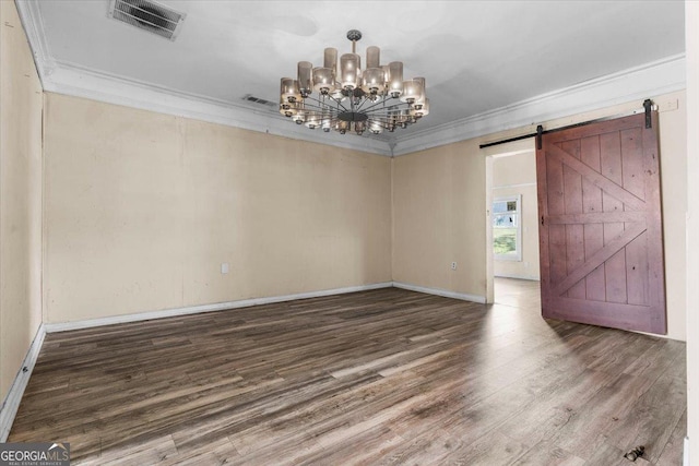 602 W Lake Ave NW, Atlanta, GA 30318 - spare room featuring a barn door, crown molding, wood finished floors, a chandelier, and visible vents