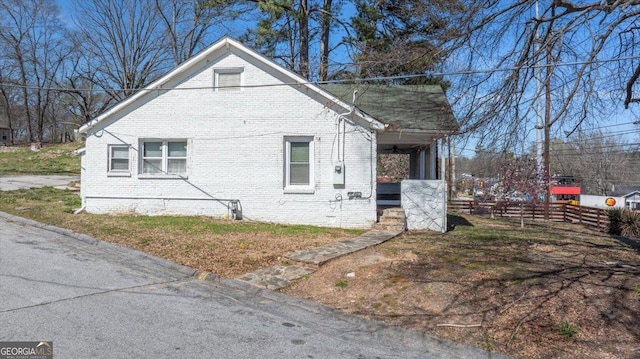 602 W Lake Ave NW, Atlanta, GA 30318 - view of side of property featuring brick siding, a porch, crawl space, and fence