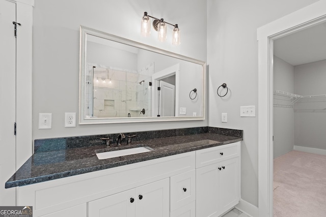 2000 Millstream Ct, Griffin, GA 30224 - bathroom featuring baseboards, vanity, a spacious closet, and a stall shower