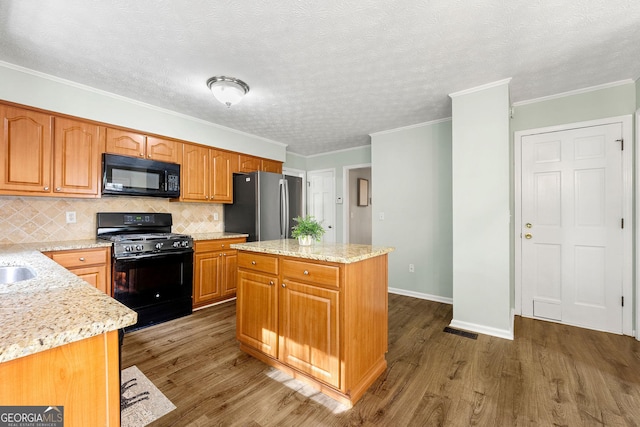 kitchen with tasteful backsplash, light stone countertops, black appliances, and dark wood-style floors