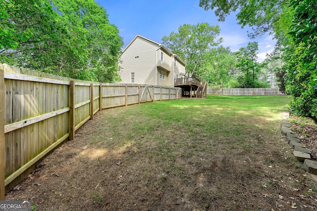 view of yard with stairs, a fenced backyard, and a deck