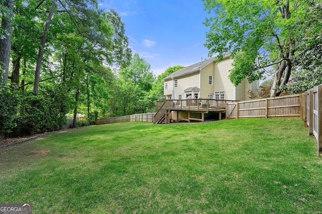 view of yard featuring a wooden deck, a fenced backyard, and stairs