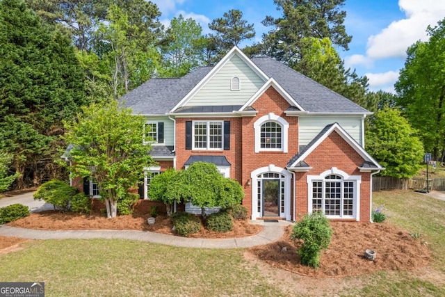 2745 Princeton Trce, Cumming, GA 30041 - colonial-style house featuring fence, a shingled roof, a front lawn, and brick siding