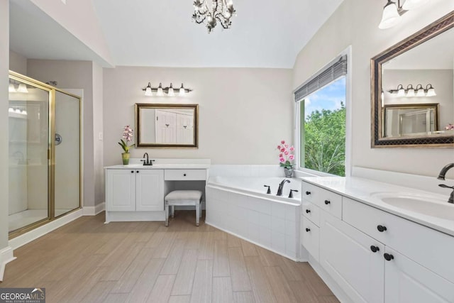 2745 Princeton Trce, Cumming, GA 30041 - bathroom featuring two vanities, a sink, a stall shower, vaulted ceiling, and an inviting chandelier