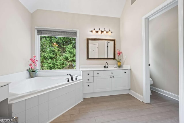 2745 Princeton Trce, Cumming, GA 30041 - bathroom with a bath, vaulted ceiling, wood finished floors, and toilet