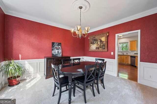 2745 Princeton Trce, Cumming, GA 30041 - dining space with light carpet, a wainscoted wall, a chandelier, and ornamental molding