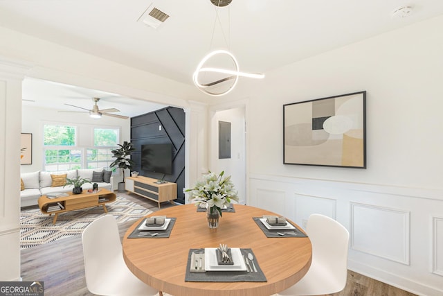 1258 Lyle Ave, East Point, GA 30344 - dining area with visible vents, wood finished floors, a decorative wall, ceiling fan, and ornate columns